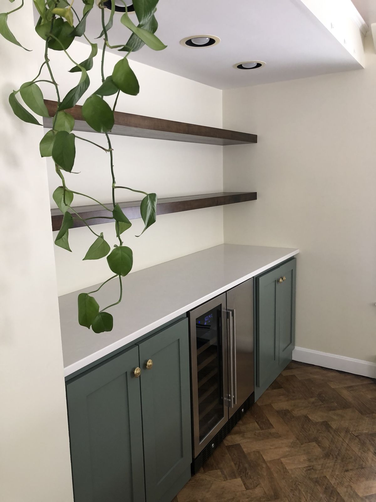 Beverage center with green cabinets and wine fridge