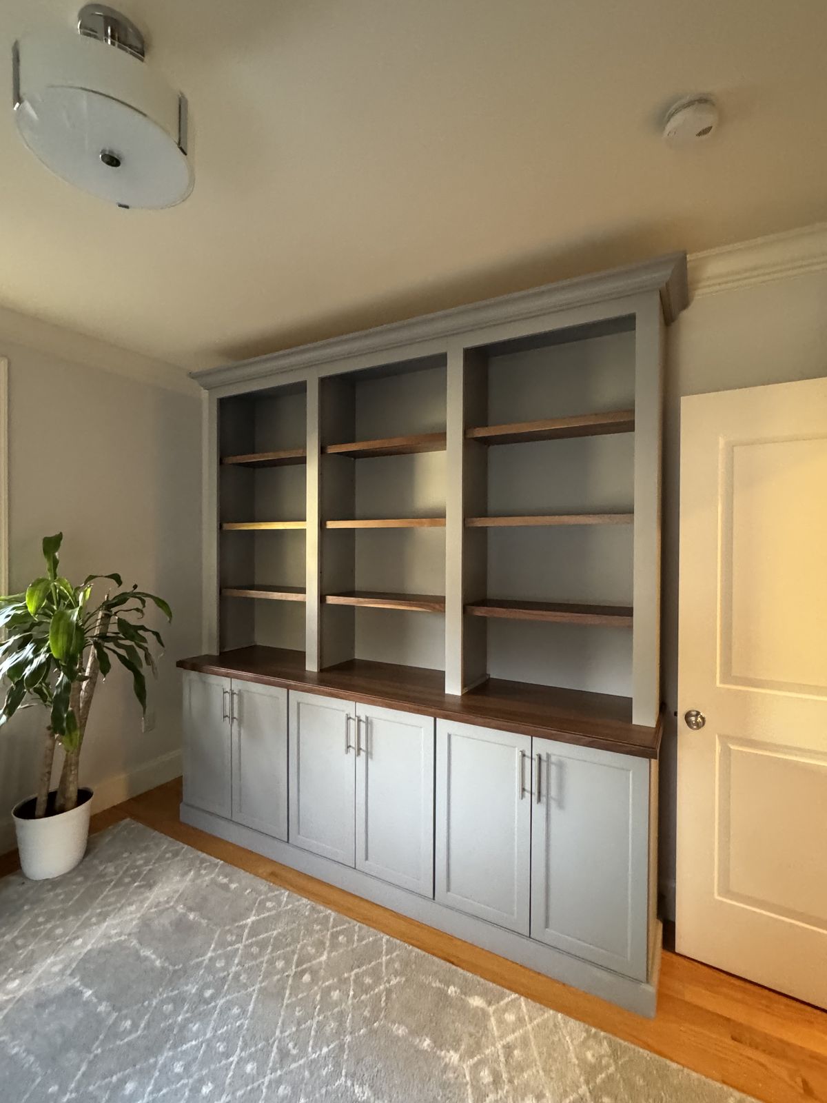 Built-in cabinet with open shelving over wood counter