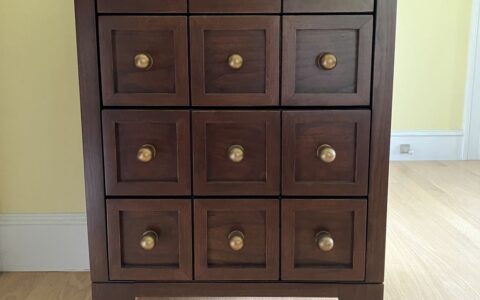 Dark apothecary chest with brass knobs