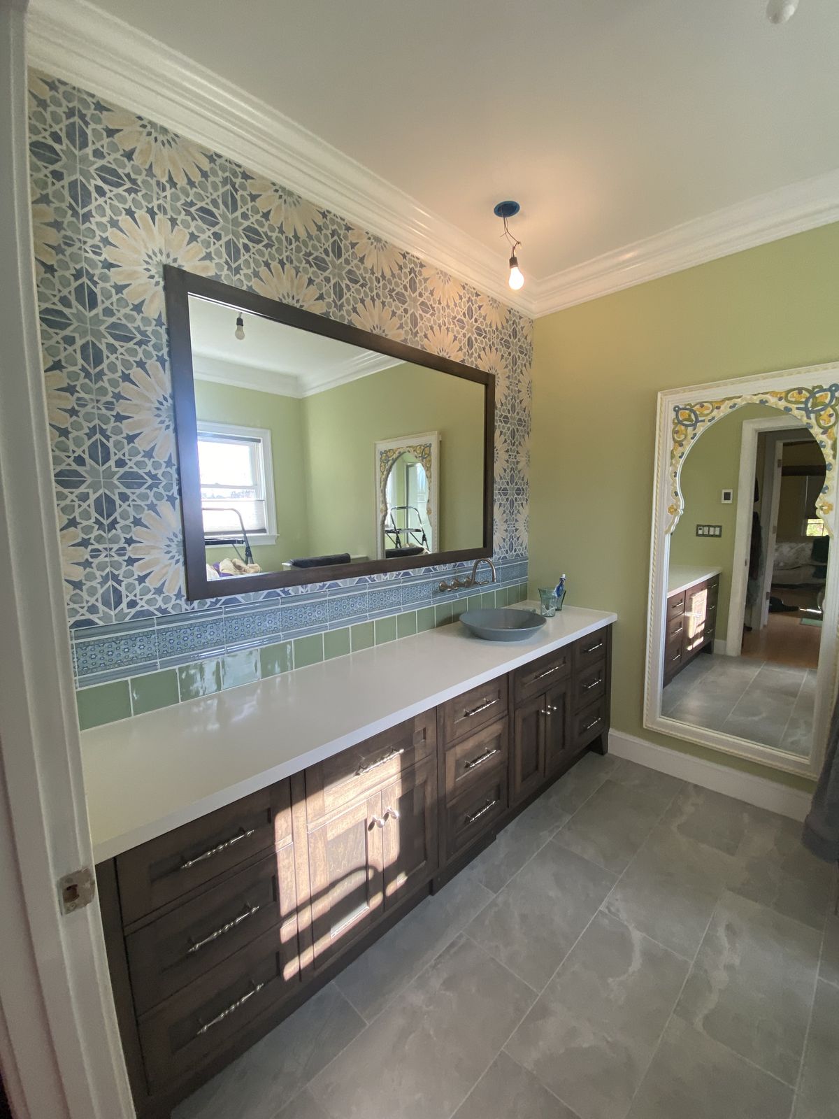 Dark vanity against patterned wall