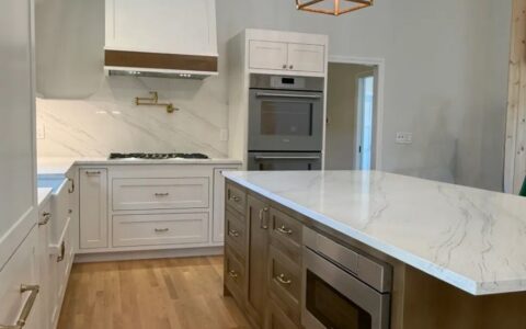 Kitchen with gold pendants and marble island