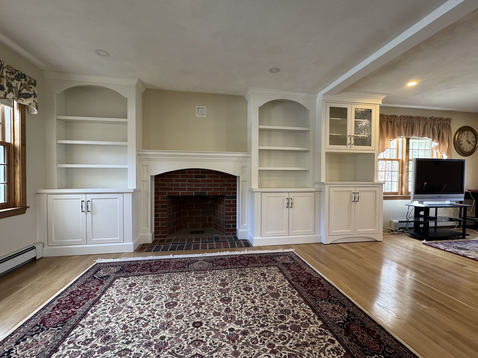 Living room built-ins flanking brick fireplace