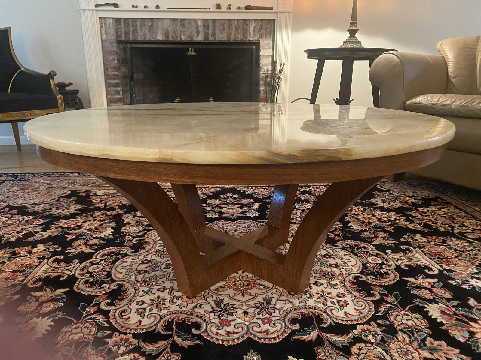 Round stone-top table on sculptural walnut base