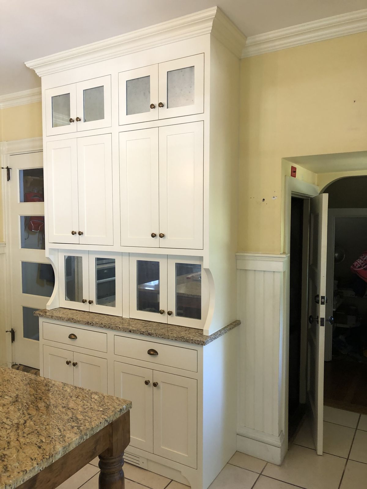 White hutch cabinetry with granite